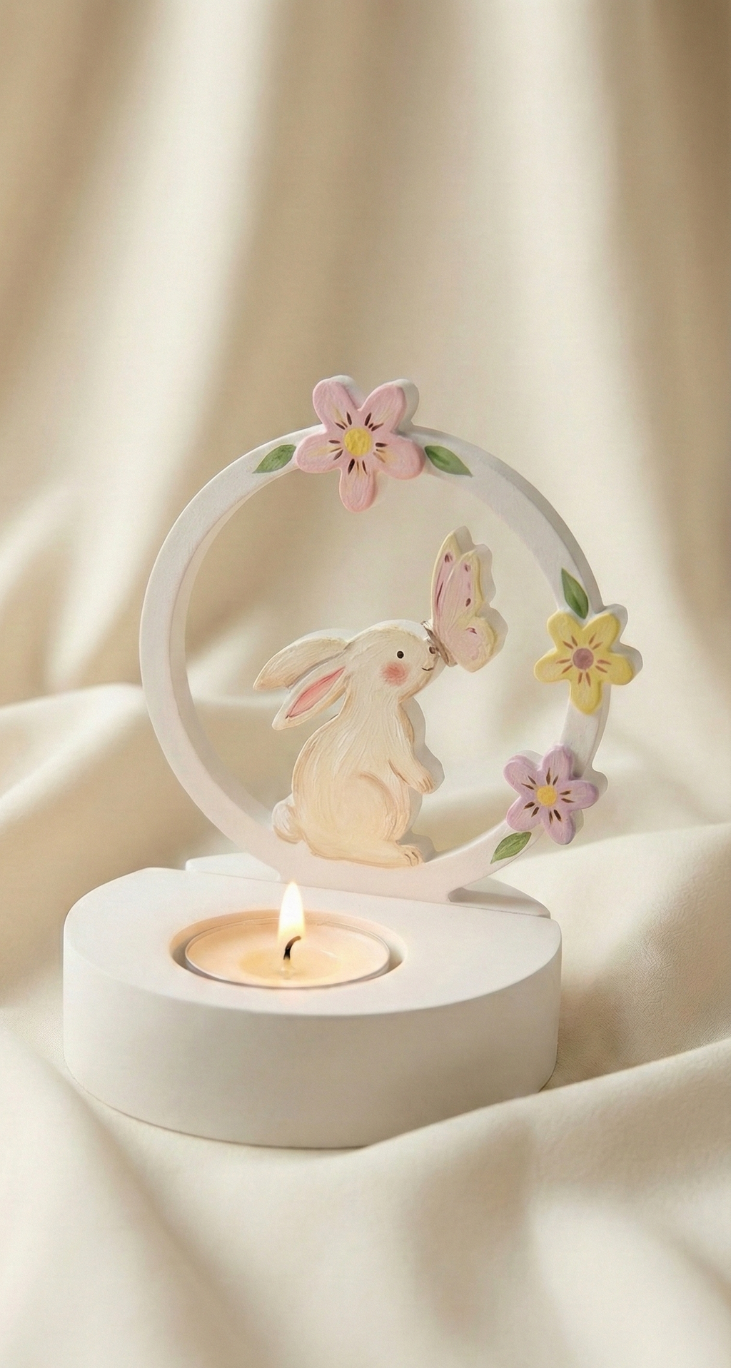 Decorative candle holder with a rabbit and flower design on a soft beige background