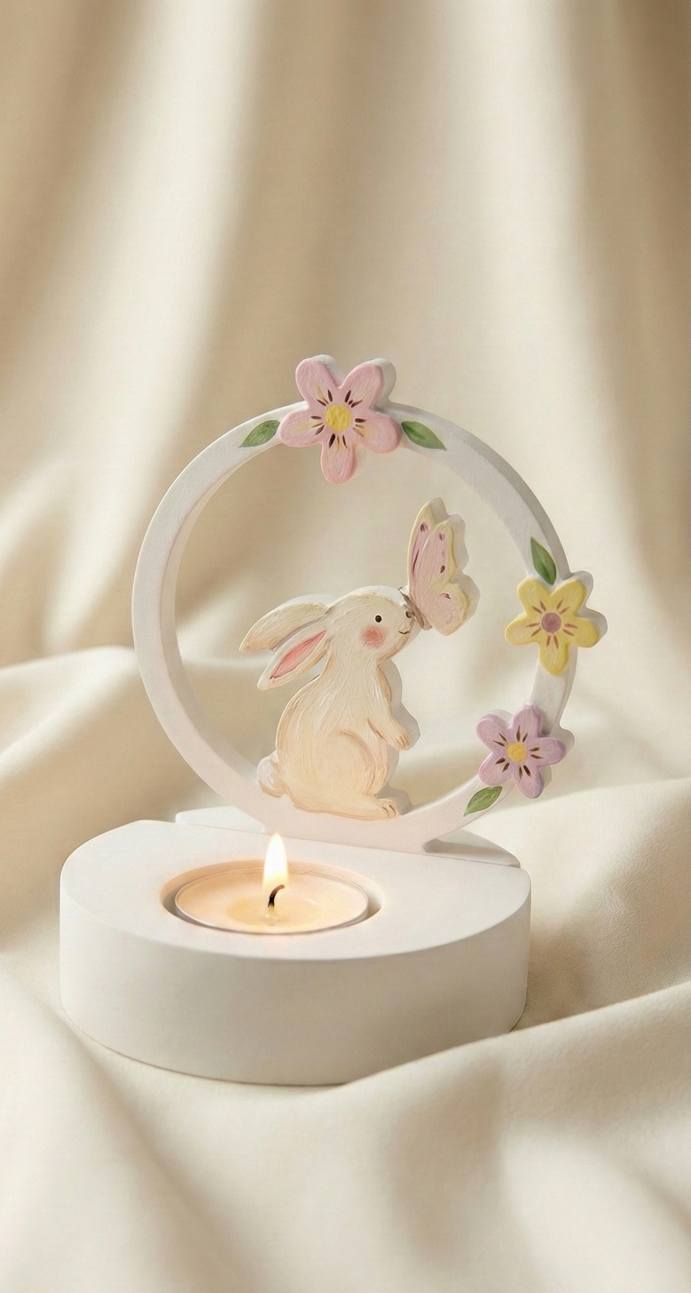 Decorative candle holder with a rabbit and flower design on a soft beige background