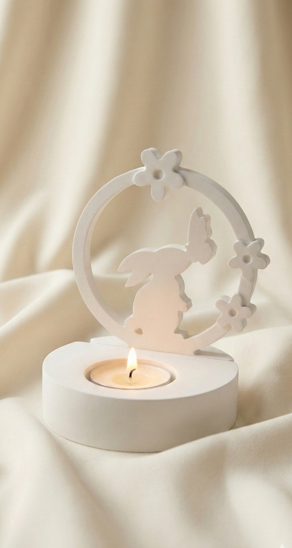 Decorative candle holder with a butterfly design on a soft beige background